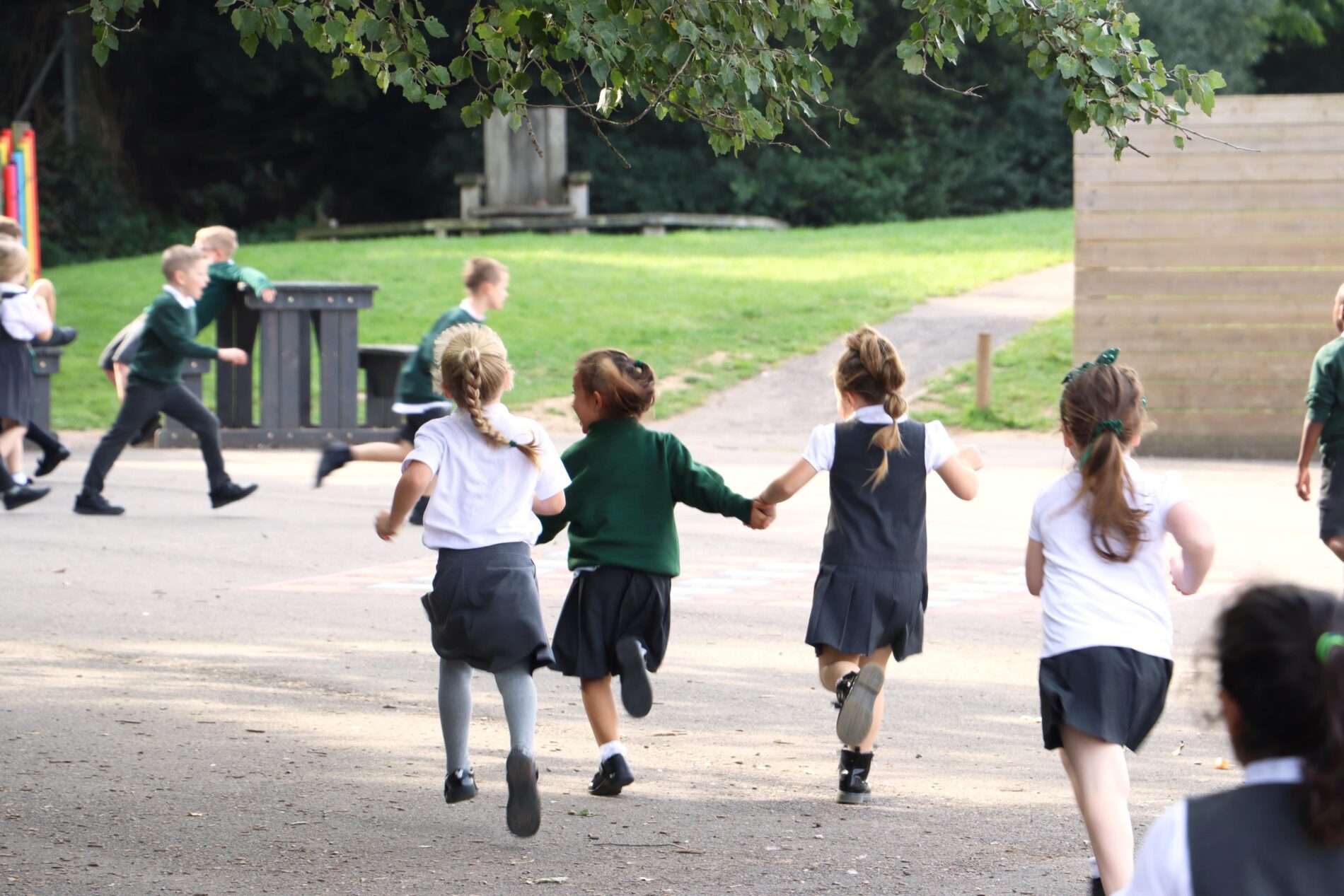 IMG_0672 kids running in playground holding hands