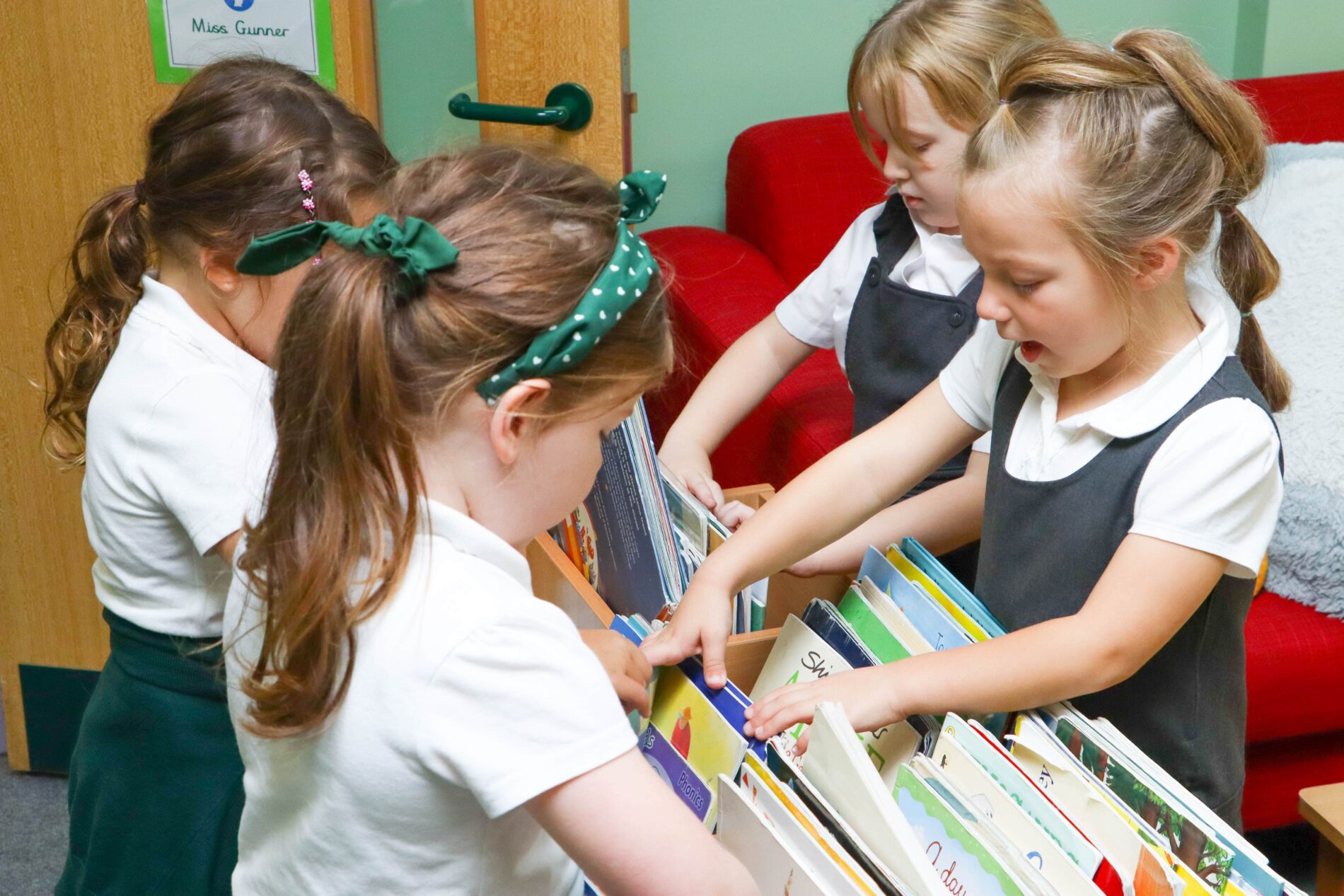 pupils picking out a book to read in English class