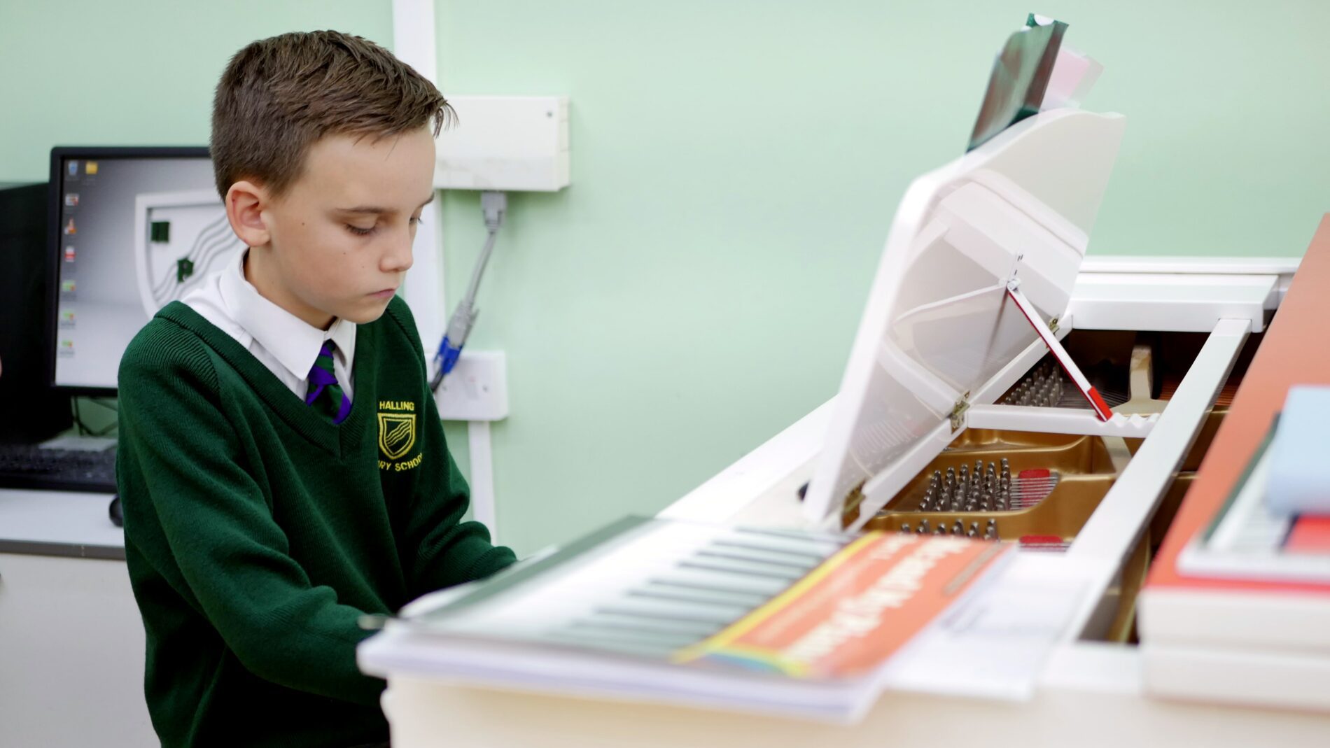 halling pupil playing piano for an external music lesson