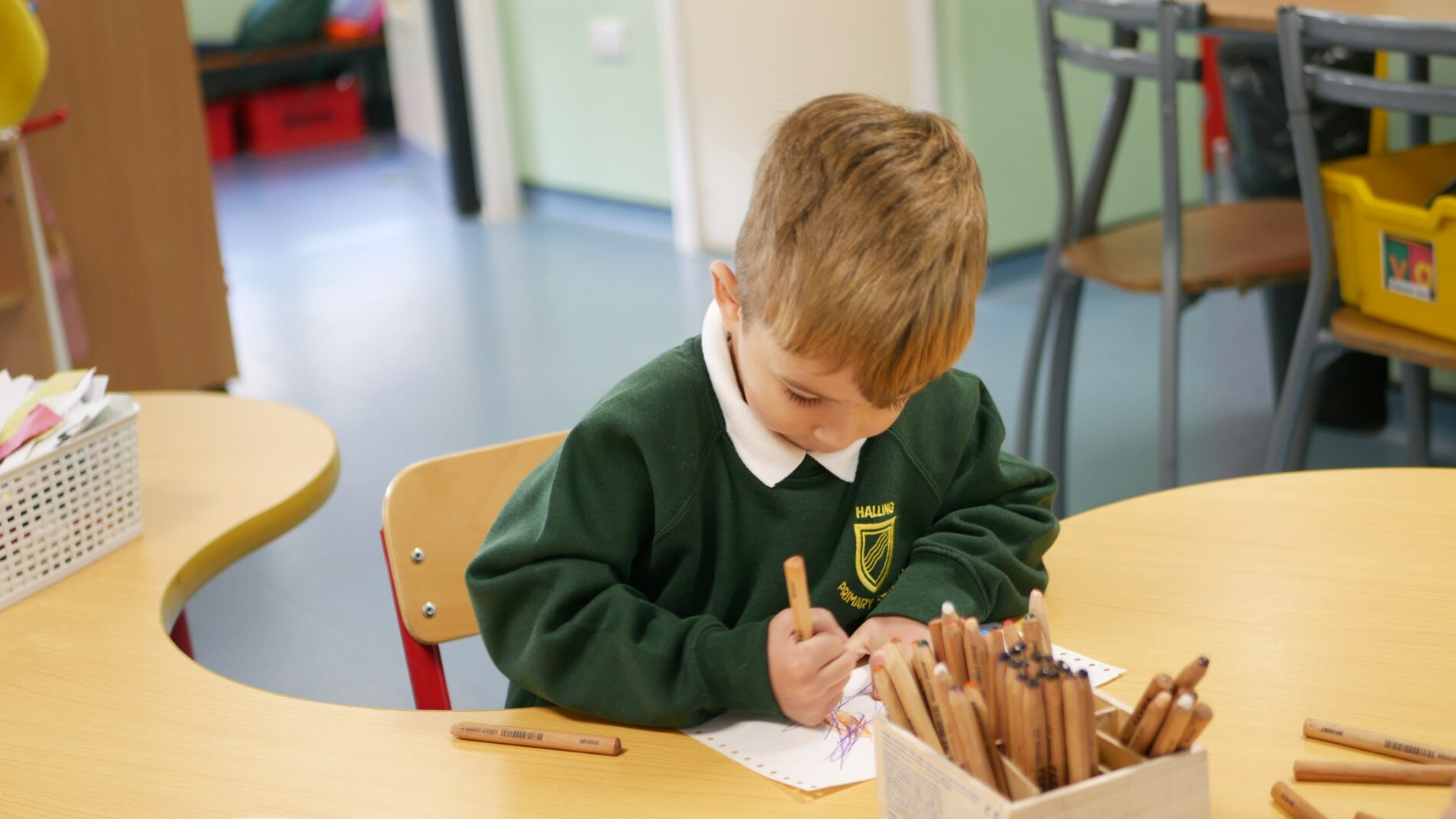 child drawing in art lesson at halling primary school