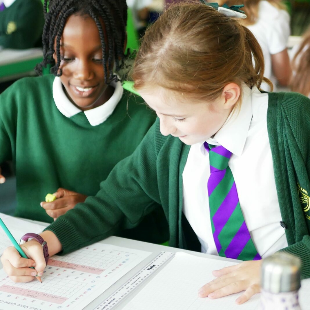 pupils helping each other in maths lesson at halling primary school
