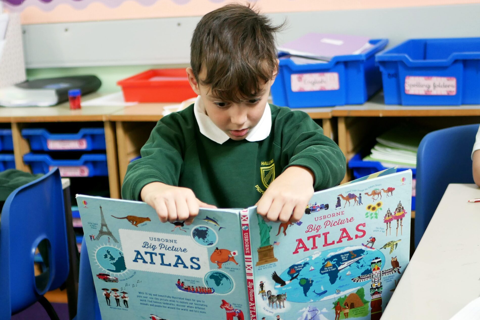 halling pupil looking at an atlas
