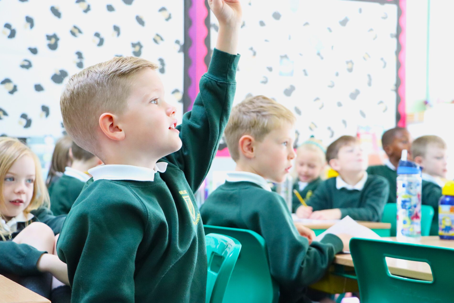 pupil with hands up in class at halling primary school