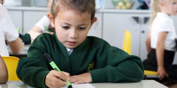 pupil writing phonics in lesson