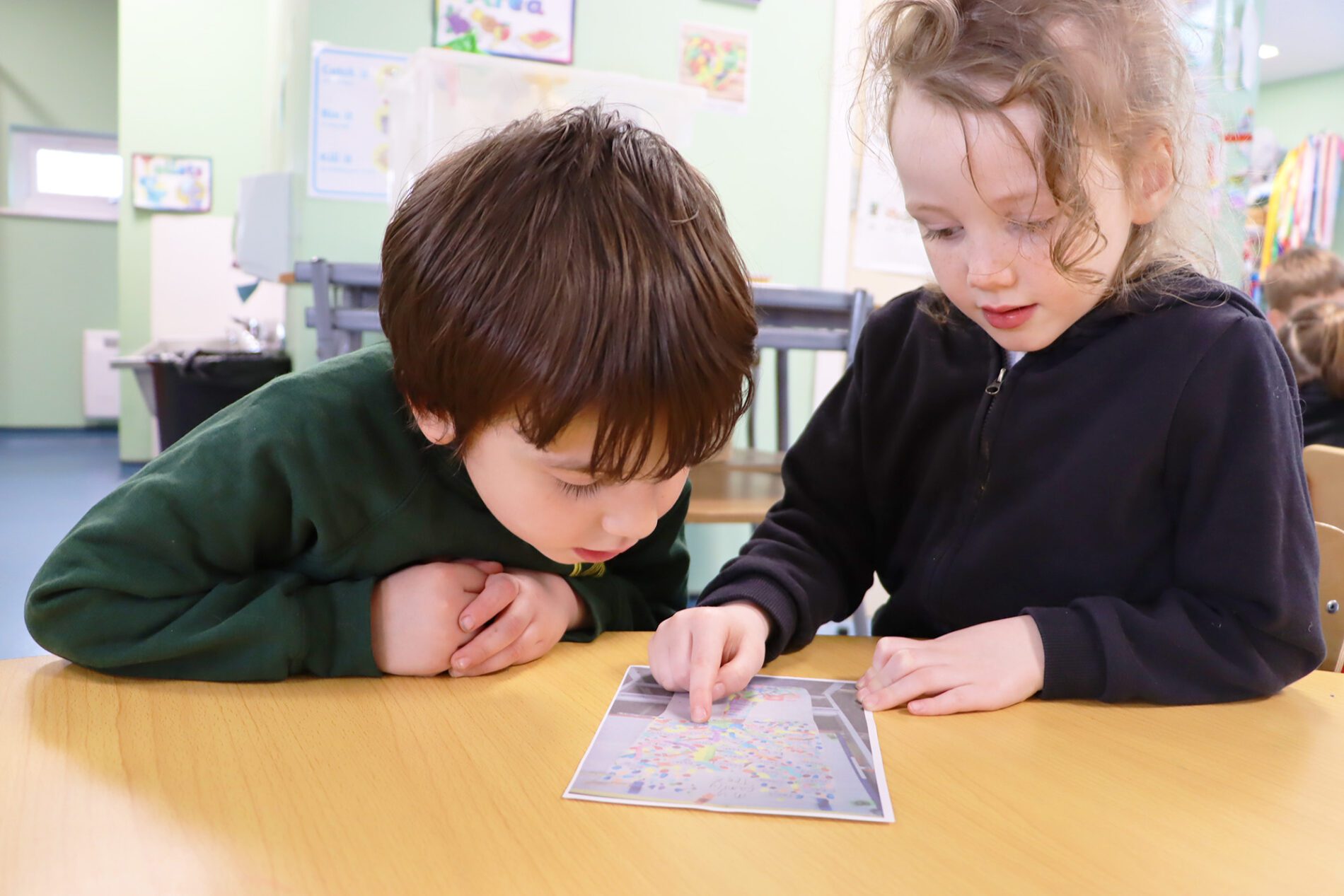 two children discussing their family trees at halling primary