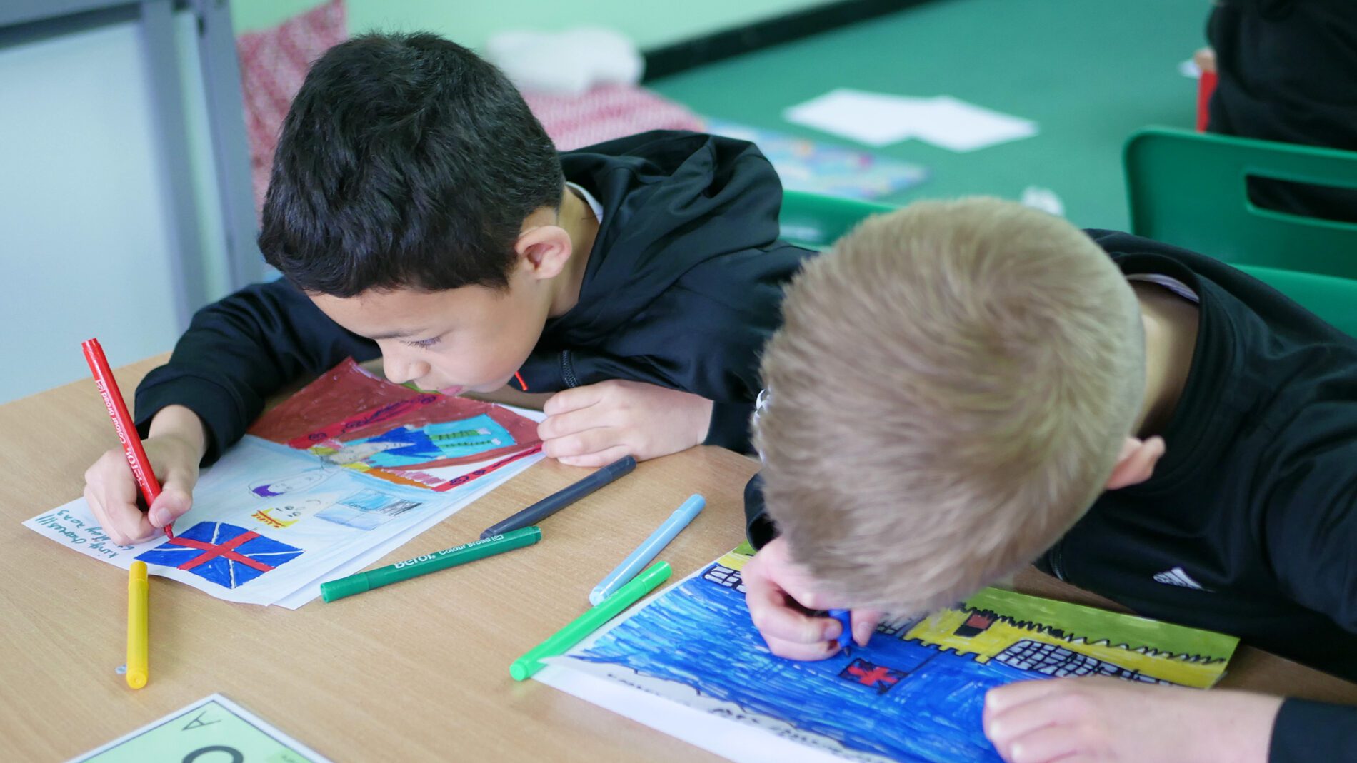 pupils creating coranation posters in history lessons